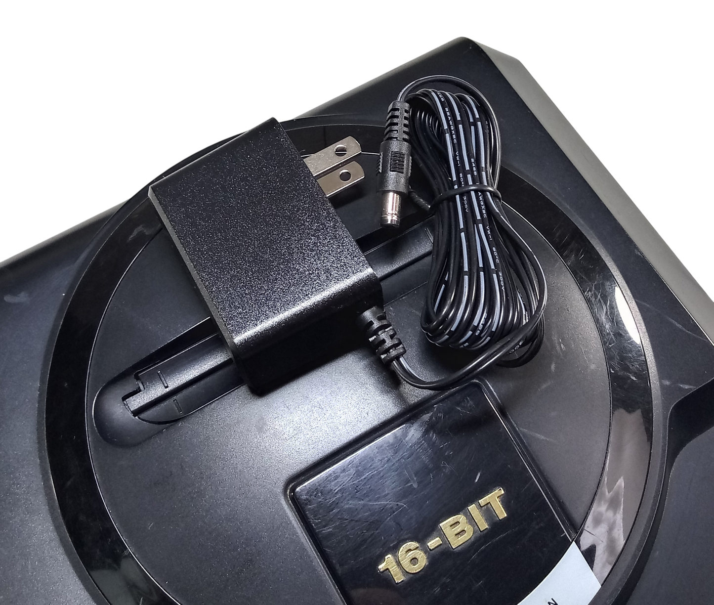 Regulated power supply for Sega Mega Drive / Genesis 1 with US plug on top of the console